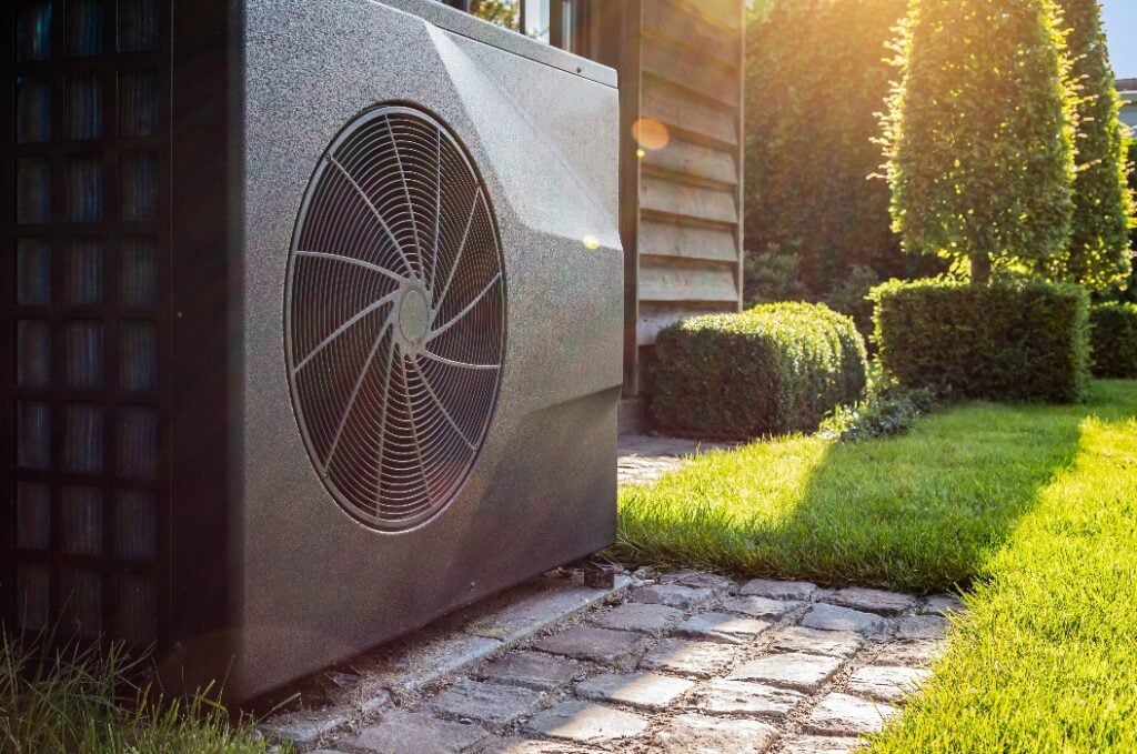 Air heat pump near pool house outdoors.